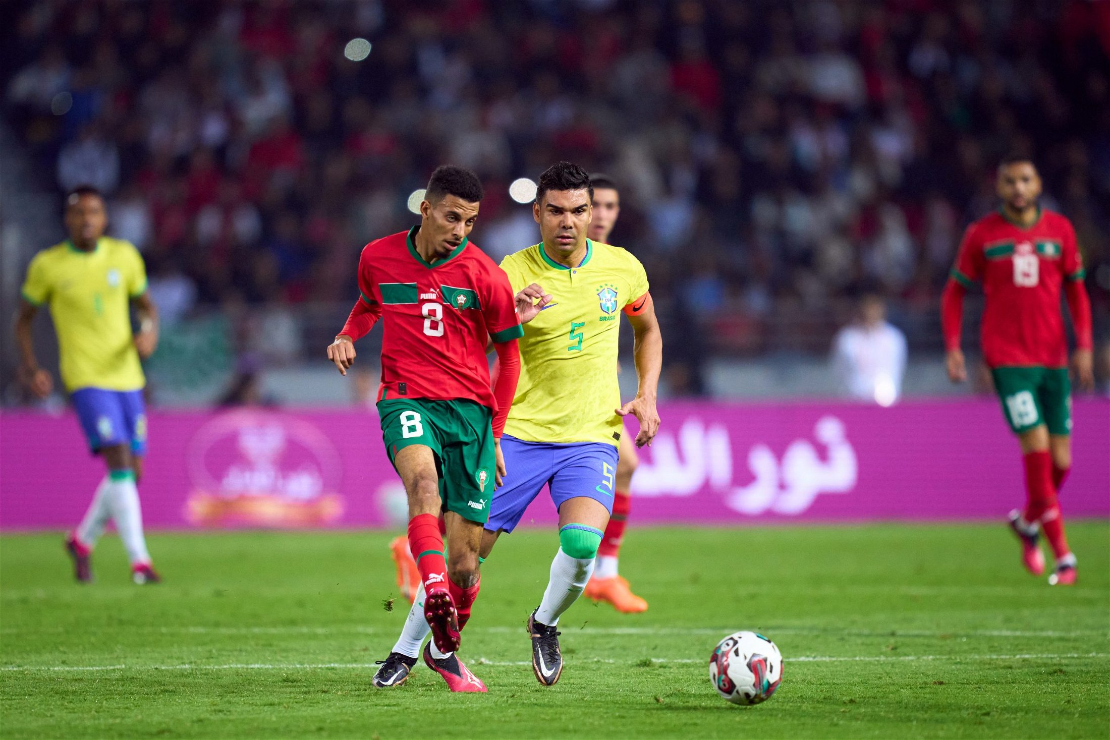  A photo of a soccer match between Morocco and Brazil with the caption 'Leeds United transfer spending financial maneuvering'.